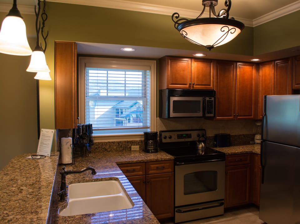 Fully equipped kitchen with granite counter tops and stainless steel appliances 
