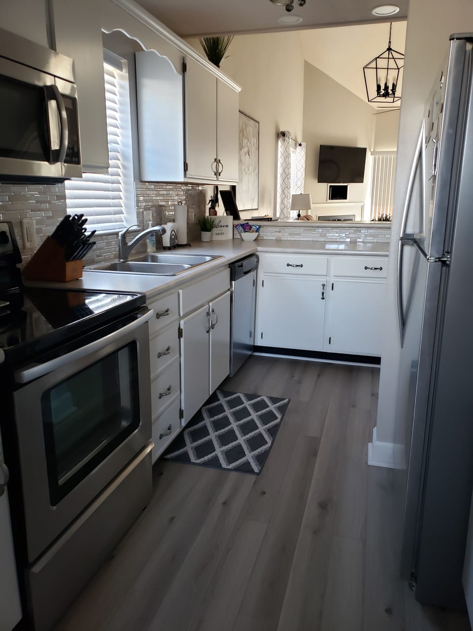 Fully stocked kitchen with stainless appliances. 