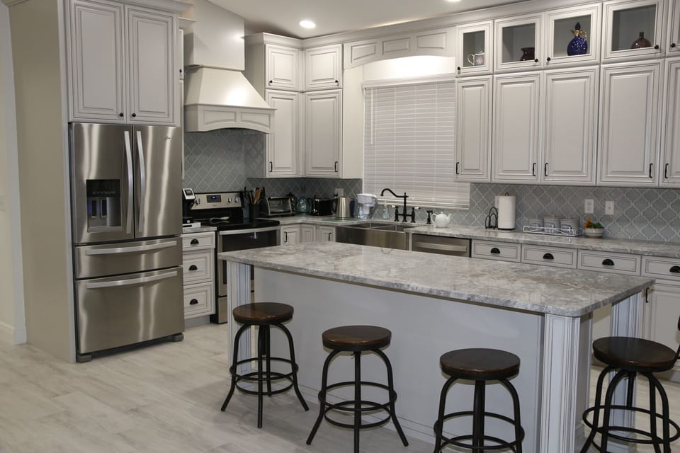 Elegant French-style kitchen with sleek countertops and classic cabinetry.