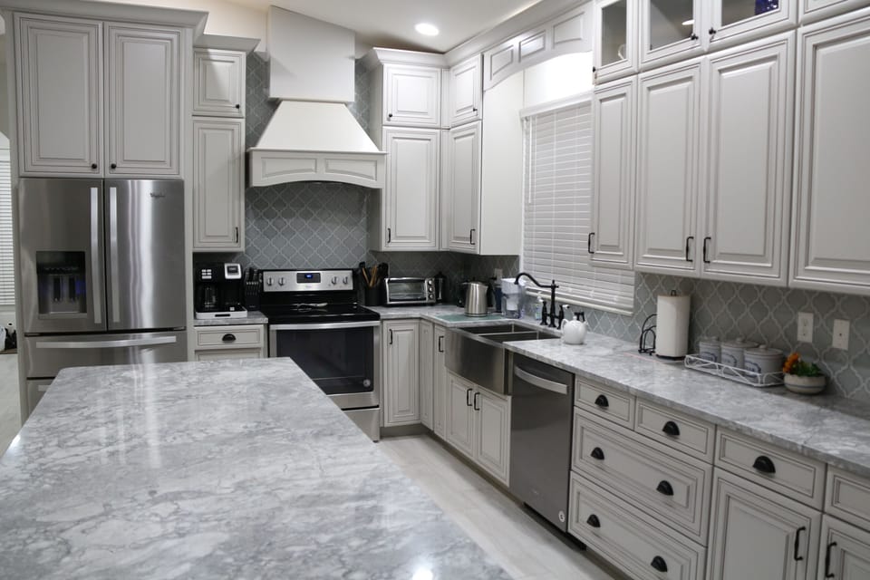Elegant French-style kitchen with sleek countertops and classic cabinetry.