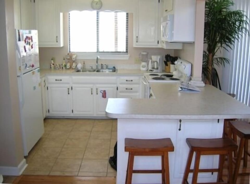 Kitchen has all new appliances,is generously stocked! Breakfast bar seats 4.