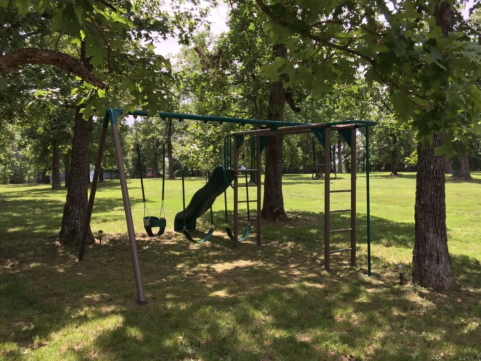 The playground with swings, slide, and monkey bars to keep kids busy!