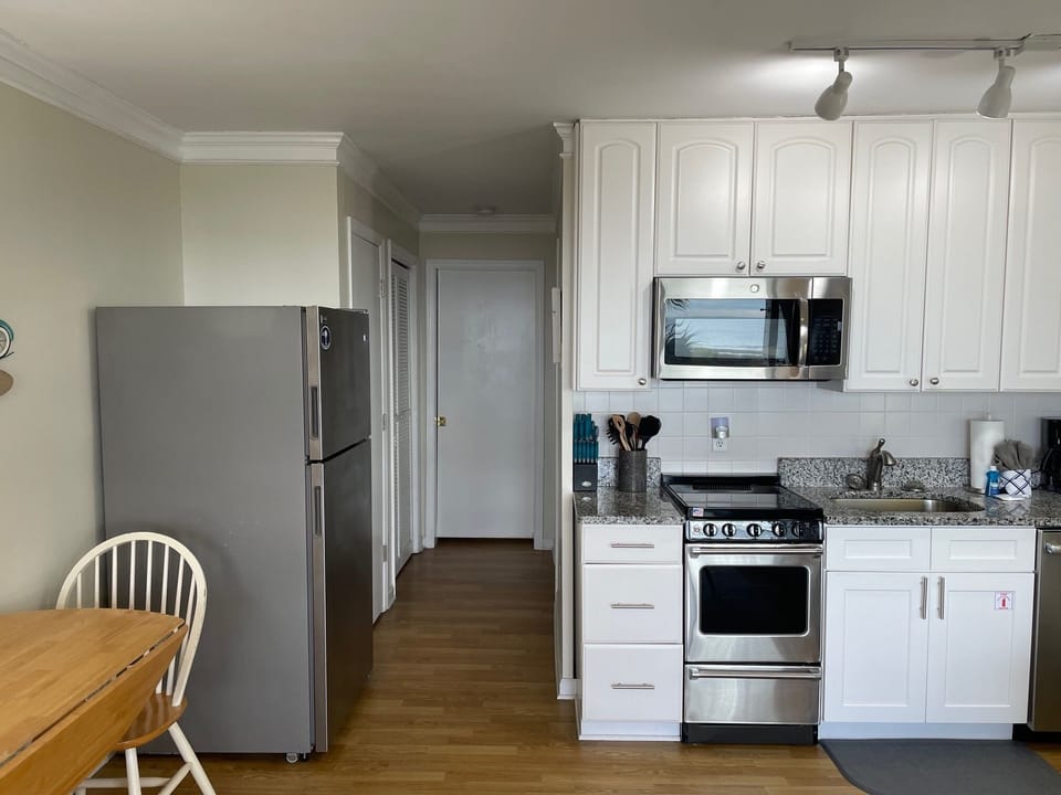 Pocket door separates bedroom from living room/kitchen area for privacy.
