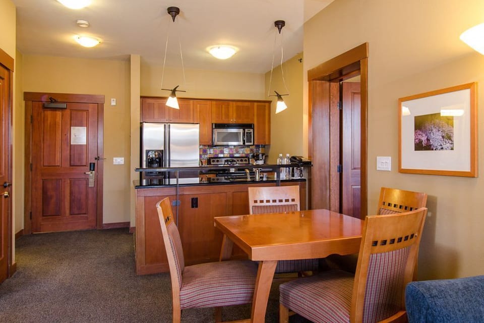 The open-concept design allows for easy flow between the living room, dining room, and kitchen, creating a warm and inviting atmosphere.