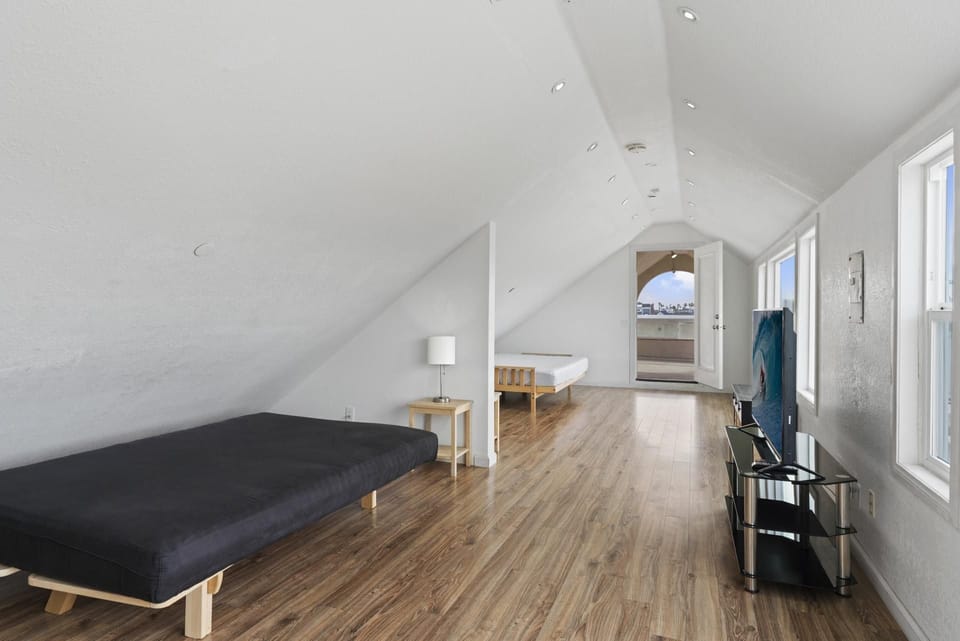 Enclosed third level bonus room provides two full-size futon sofabeds, linens, and TV. Check listing for age appropriate use, as it's not completely connected to main upper unit.
                