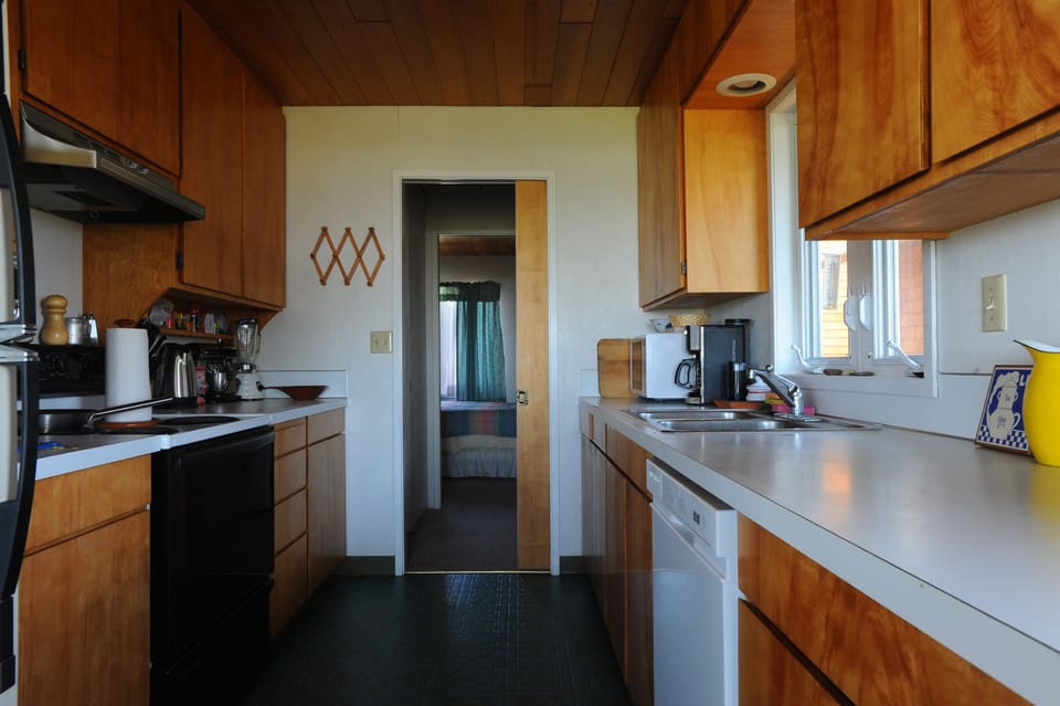 Convenient clean kitchen opens onto living area so the chef doesn't miss a beat.