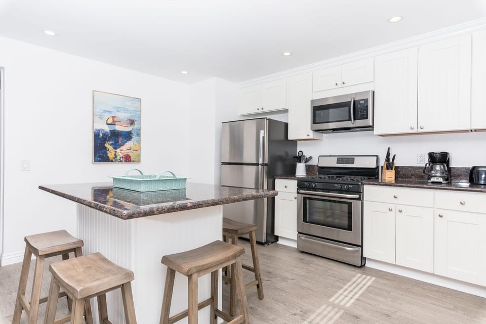 Kitchen comes stocked with gear for meal prep and dining (dishes, glassware, flatware, cookware, bakeware, etc.) as well as major and small appliances.
                