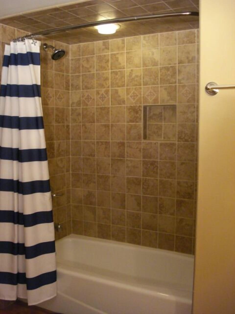 Full bathroom with newly tiled shower.