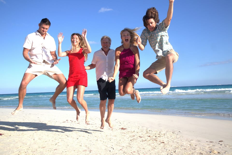 Pamela & family jumping for joy right in front of Sunset Fisherman's resort