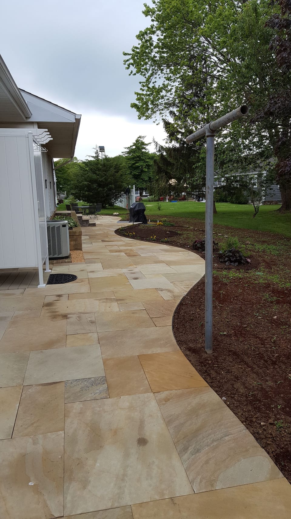 Patio across back of house- Outside shower and clothes line for towels 
 & suits
