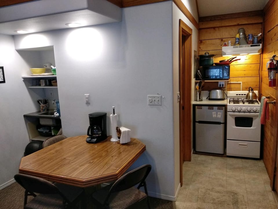 Kitchen allows cooking and enjoyable private dining. Dishes, cookware utensils..
