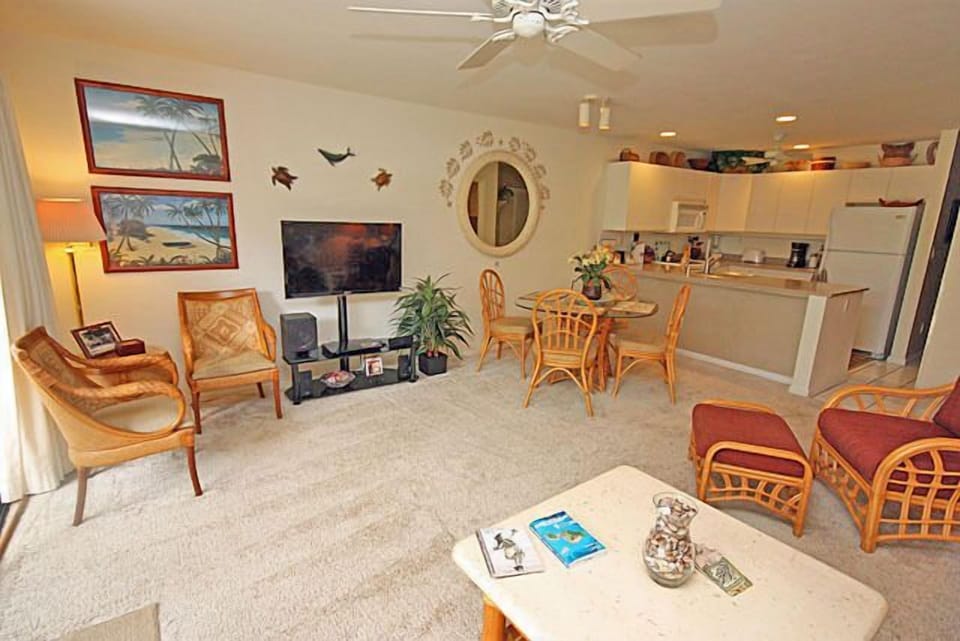 A long shot view of the kitchen and dining area from the living room.