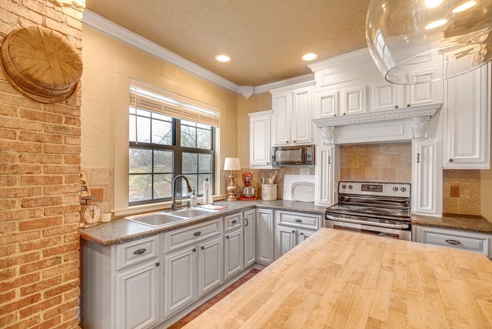 The original brick chimney and wood floors remain in the kitchen.
