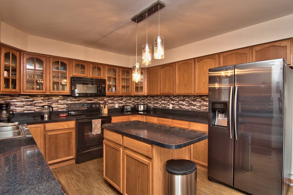 View from kitchen shows an open layout with connected dining room, living room
