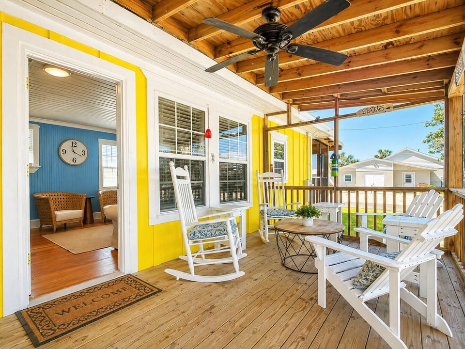 Side screened porch with more outdoor seating off the living room