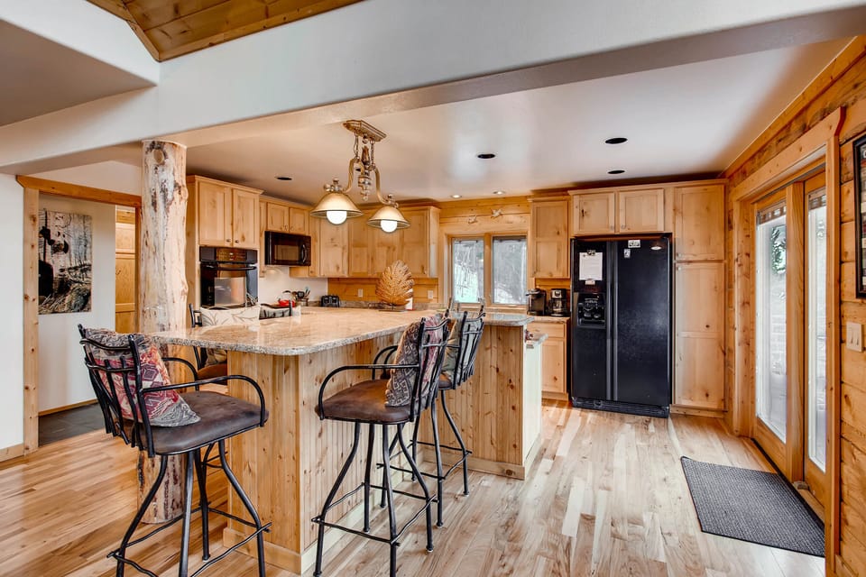 A view of the kitchen island and kitchen.