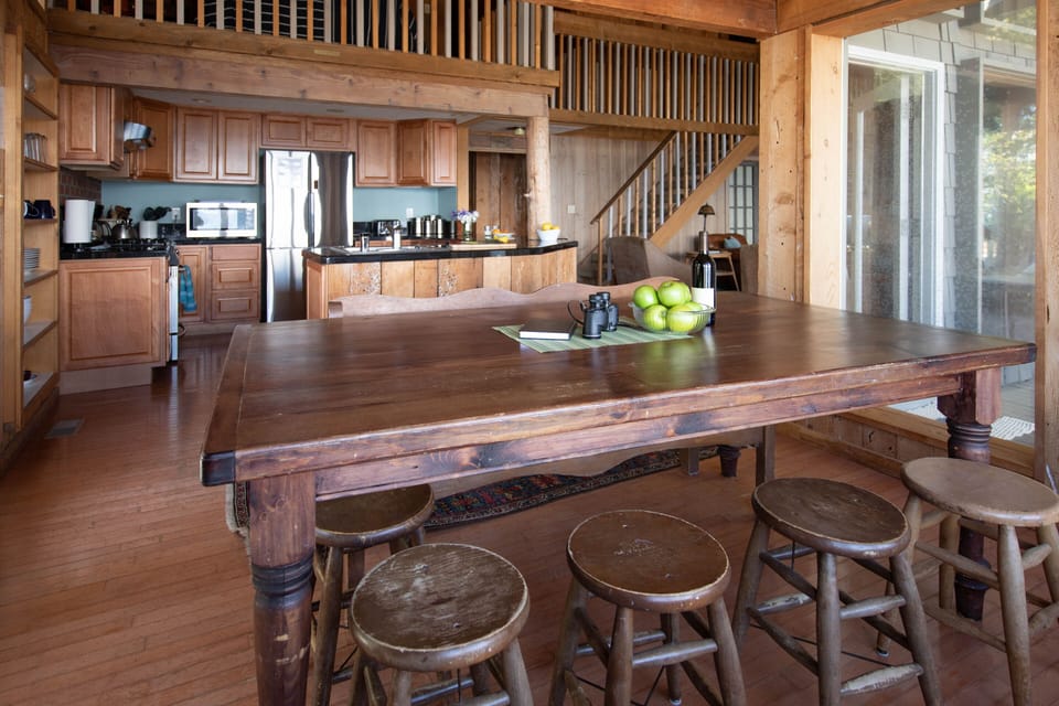 Dining room table with kitchen in background