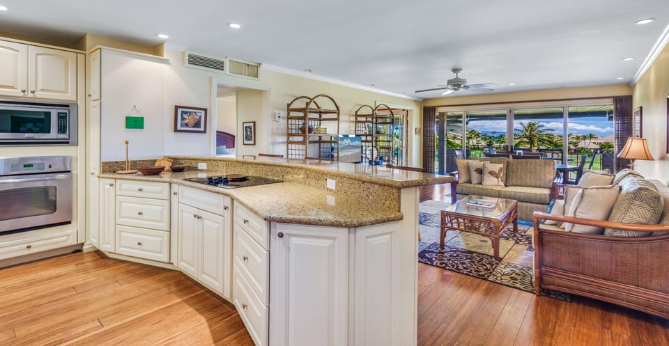 Cooking island has open view onto living room and dining area.