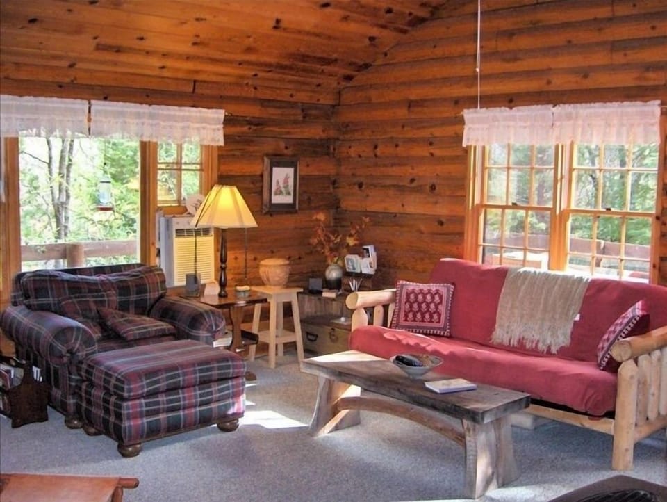 A comfortable, inviting livingroom with a hearth stove.