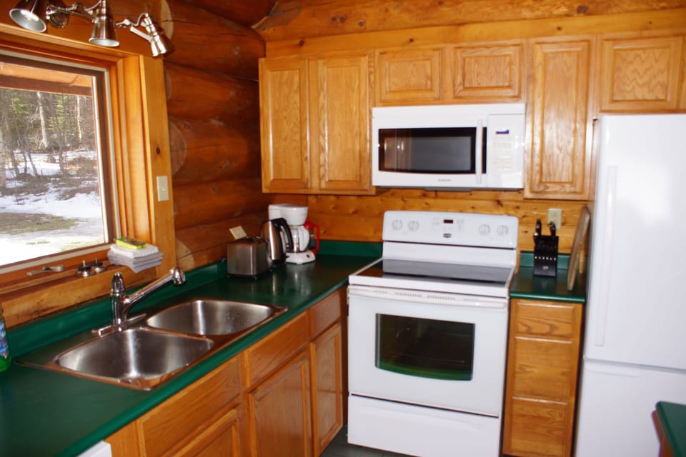 Kitchen area which includes fridge, microwave, stove and dishwasher.