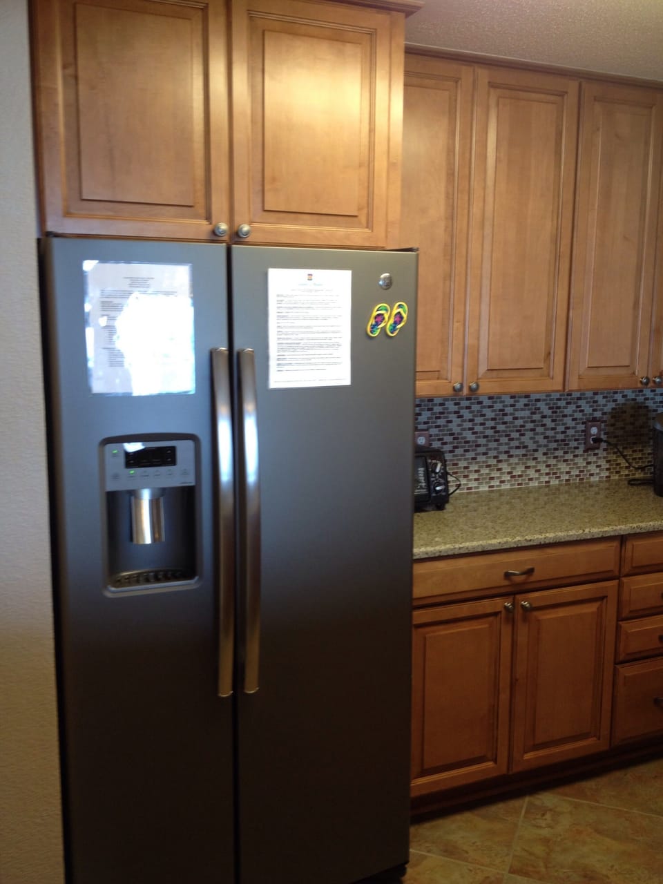 GE side-by-side refrigerator with water and ice in the door.