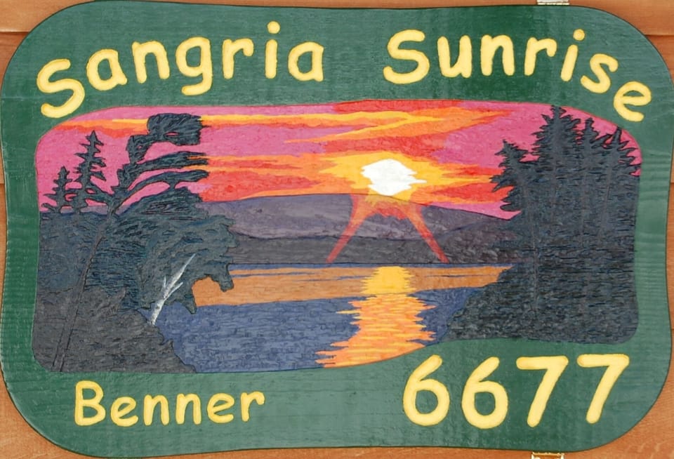 Sangria Sunrise sign on front of cottage