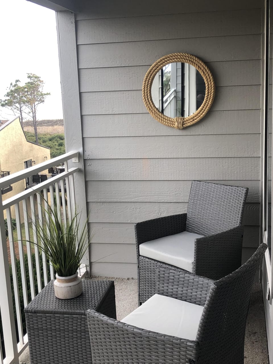 Comfortable seating on balcony with side view of ocean