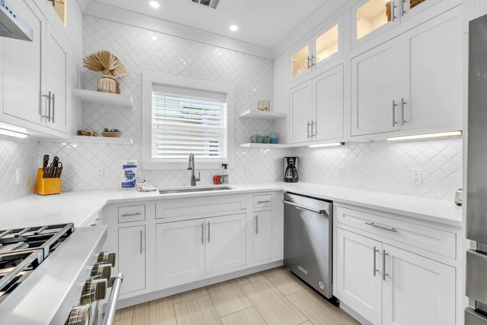 Stainless steel appliances, including dishwasher and fridge with icemaker.