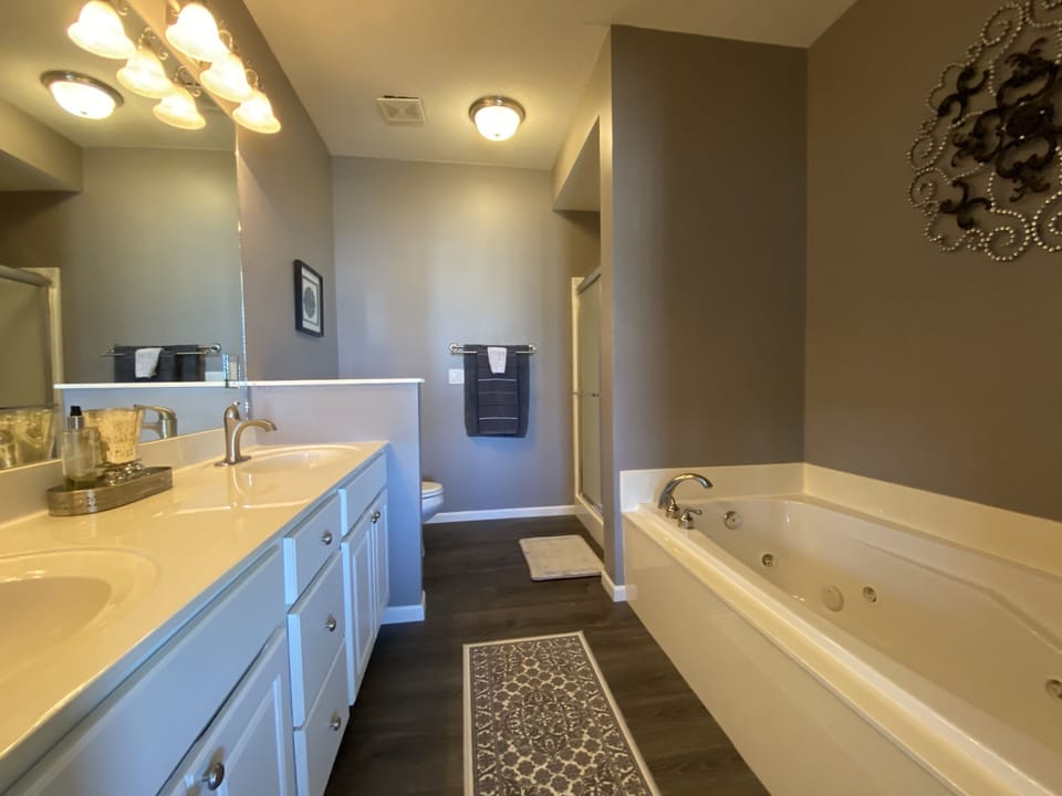 Large, jetted bathtub, walk-in shower, double sinks