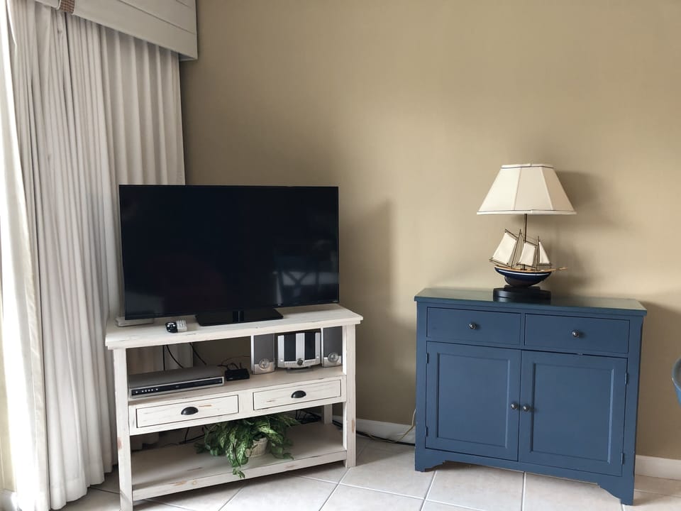 Relax in our spacious living room featuring balcony access and a flat screen TV!