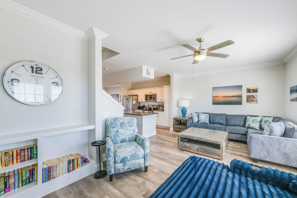 Relax in your bright, open living space with coastal décor, built-in library, and seamless flow to the kitchen.