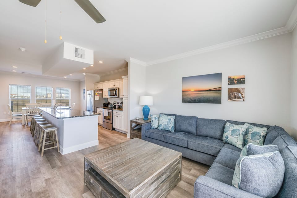 Sink into your spacious sectional sofa and take in the open-concept design where kitchen conversations flow seamlessly into living room relaxation.