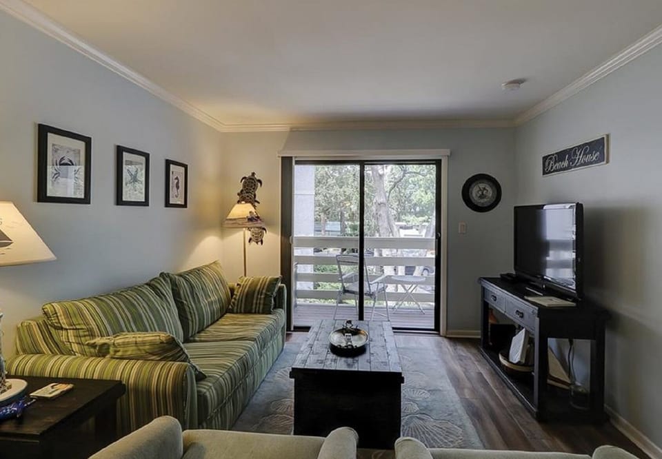 Living room over looking balcony with flat screen tv