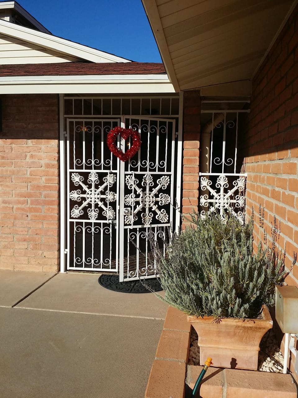 Gate leading to entrance and main and guest house exterior doors.