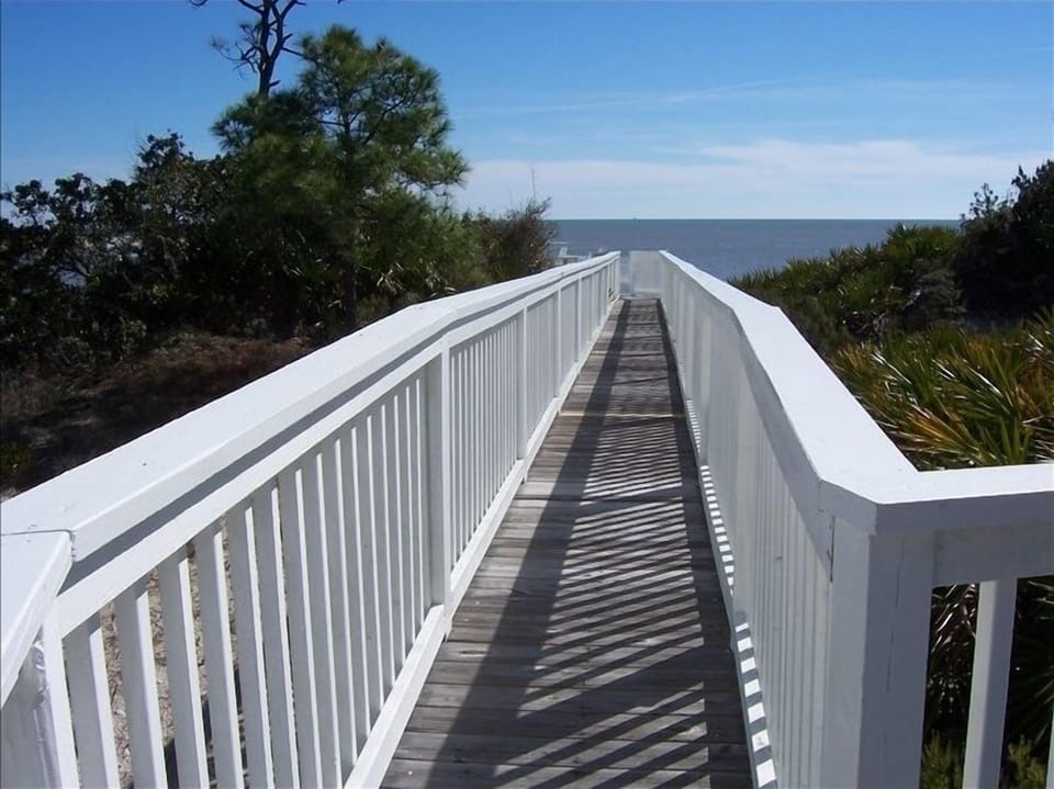 Home's boardwalk takes you over lush vegetation and sand dunes to the beach.