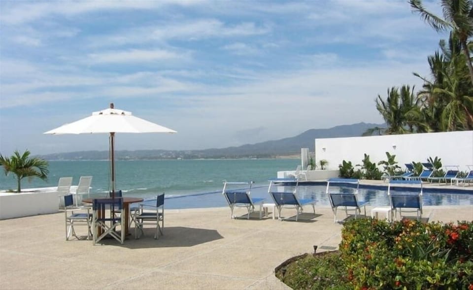Chaise lounges, umbrella tables and chairs on the spacious pool deck