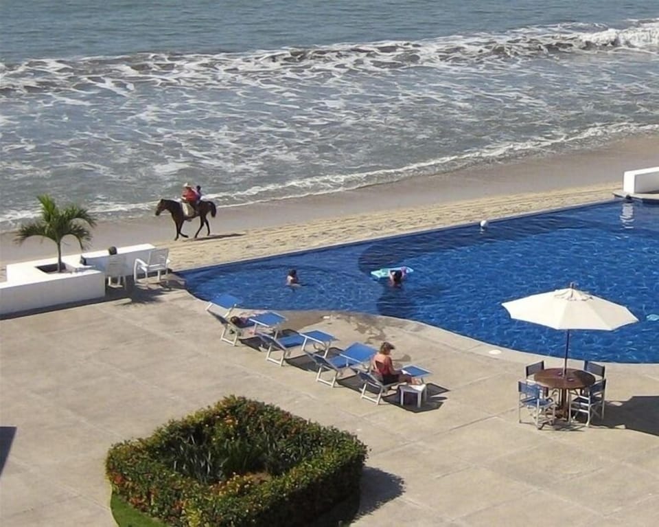 Go horseback riding on the beach in front of Condo del Mar