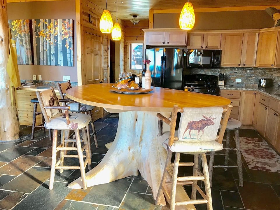 A favorite gathering place at the Kitchen Center Island Tree Stump.  