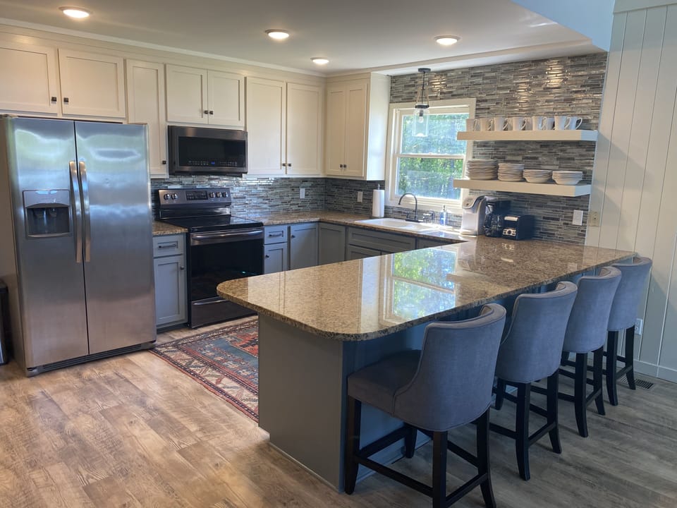 Kitchen with stainless appliances and 4 counter height barstools