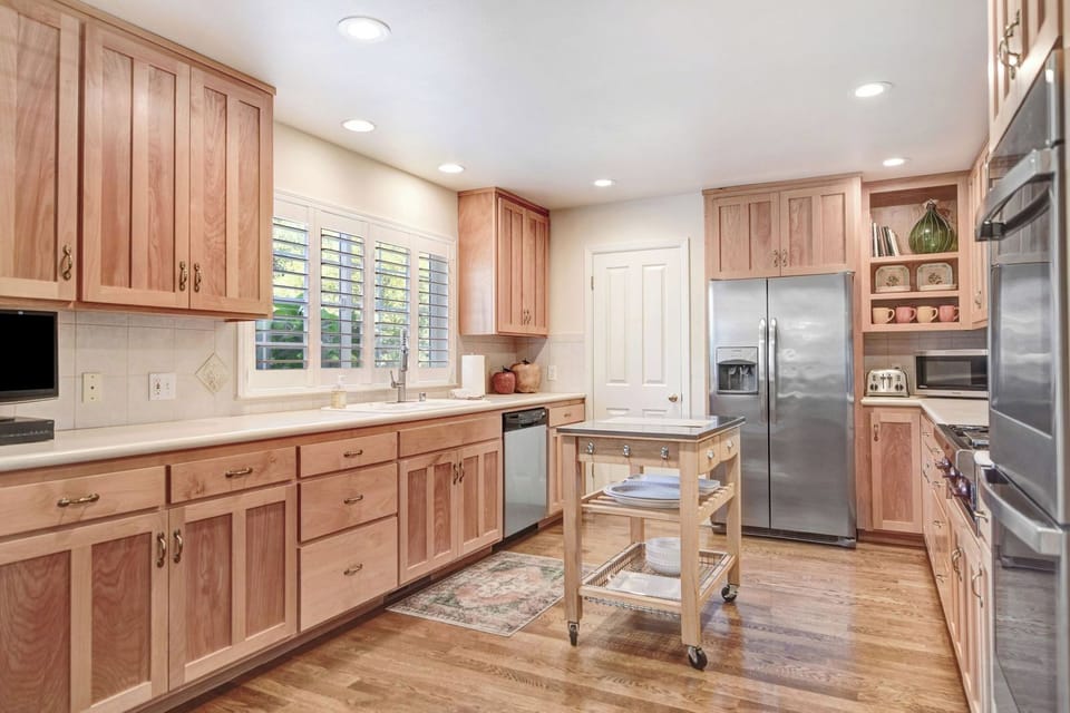Updated Kitchen with beautiful dishware, platters, high quality wine glasses