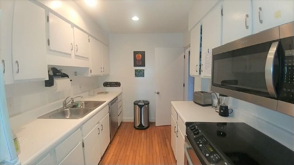 Kitchen is basic: dishwasher, microwave, smooth top range, wooden floors.