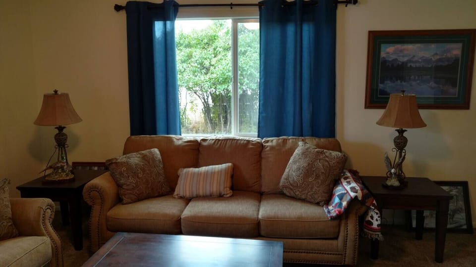 The living room  is complete with a couch, chair and a smart TV. High speed Wi-Fi is also included.