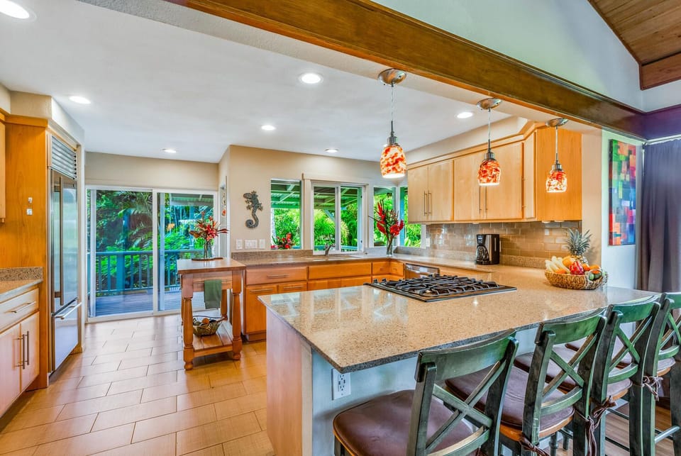 Cook with ease in the fully equipped kitchen, featuring bar seating and modern appliances for shared meals.