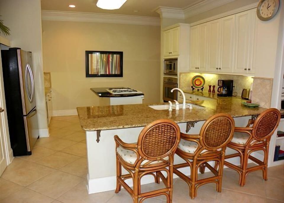 Kitchen with bar and additional seating. 
