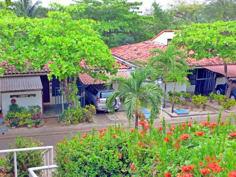Entry to Casa Uno. View from the pool stairs - car in driveway, house on left.