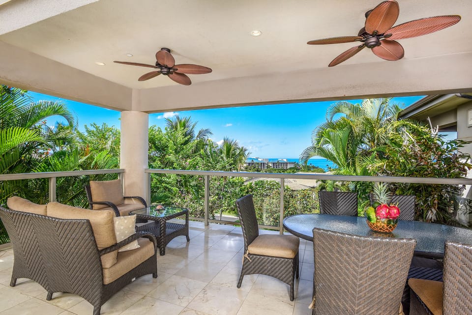 Spacious upper lanai with sliding glass doors and plenty of seating