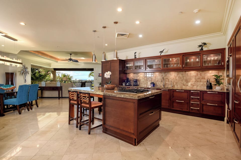 Kitchen and dinette area with living room and upper lanai in background