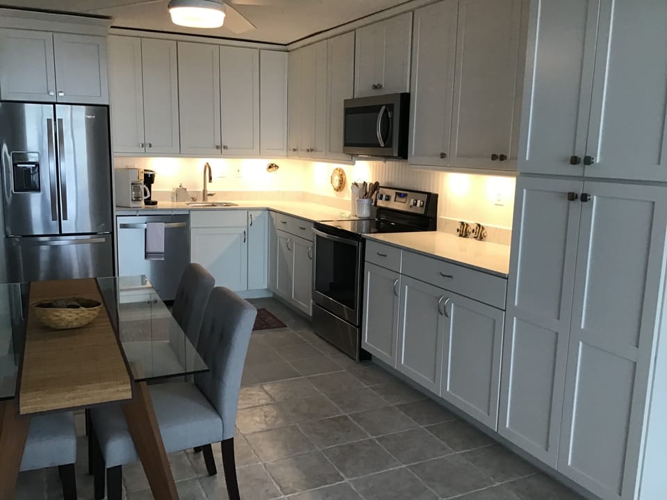 Fridge with icemaker, microwave, range, Keurig and regular coffeemakers.
