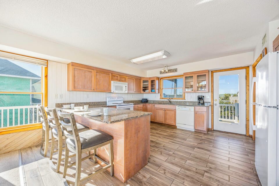 Your spacious kitchen features granite countertops, modern appliances, and breakfast bar seating where you'll love preparing meals and gathering.