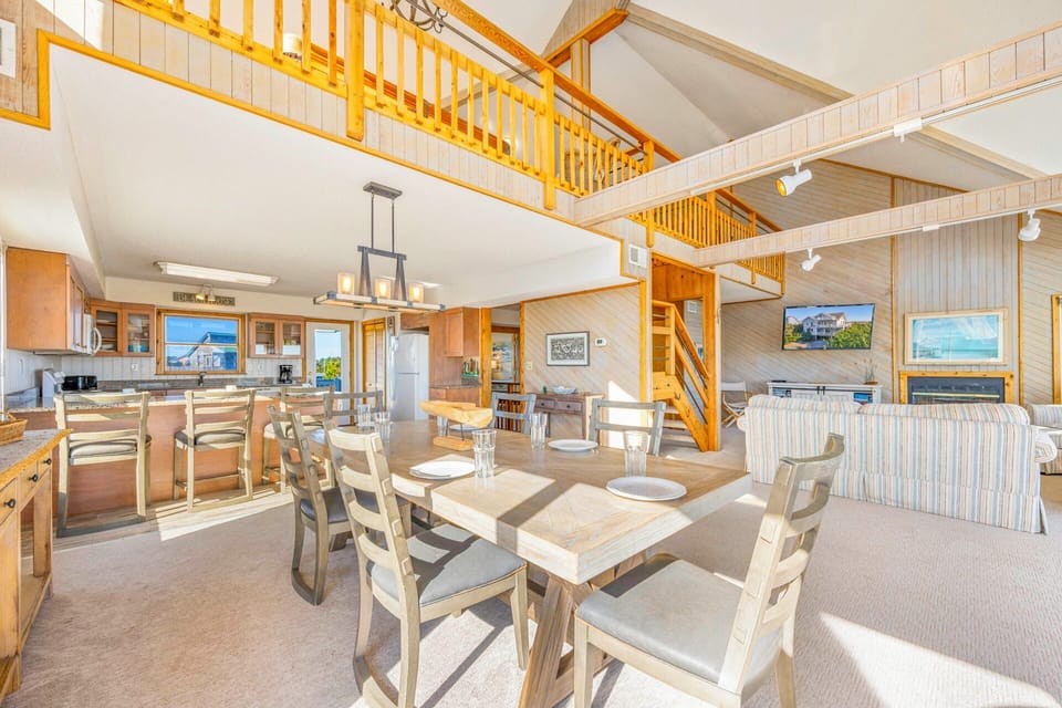 Gather around this stunning open-concept space where your group can cook together in the gourmet kitchen and share meals at the spacious dining table.